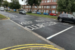 Photo of a recently resurfaced road with fresh road markings which say KEEP CLEAR
