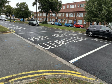 Photo of a recently resurfaced road with fresh road markings which say KEEP CLEAR
